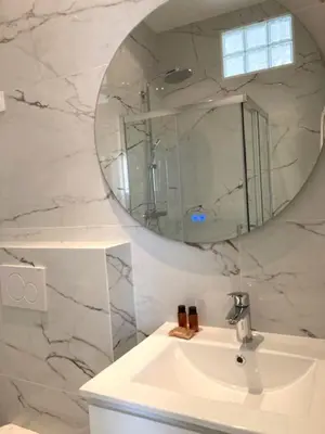a bathroom with a sink and a mirror at Hotel Cresp in Nice