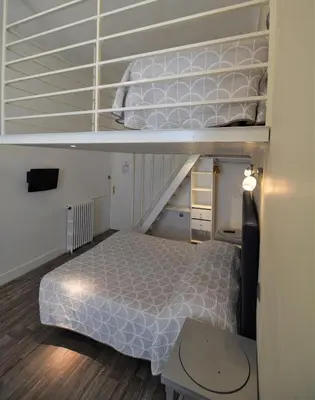 a bedroom with a bunk bed and a staircase at Hotel Cresp in Nice
