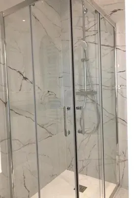 a shower with a glass door in a bathroom at Hotel Cresp in Nice