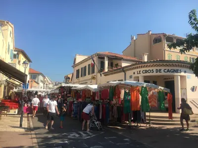 a group of people walking around a street market at Charmant 2 pièces à 50 M de la mer in Cros-de-Cagnes