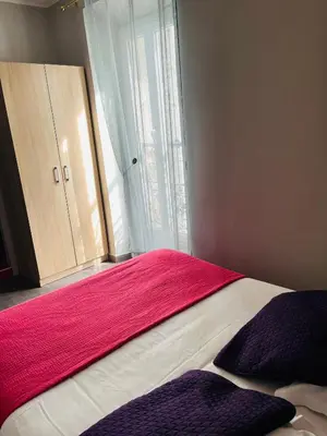 a bedroom with a bed with a red blanket and a window at Hôtel La Villa d'Eze in Èze