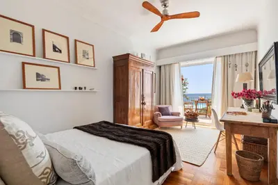 a bedroom with a bed and a desk and a window at Unique sea view apartment, center, 100m2 in Nice