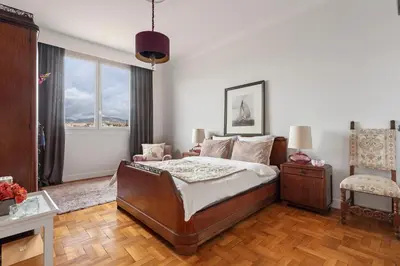 a bedroom with a bed and a large window at Unique sea view apartment, center, 100m2 in Nice