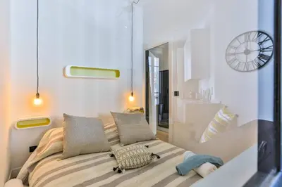 a bedroom with a bed and a clock on the wall at MY CASA - 46 GIOFFREDO - Central 1 bedroom in Nice