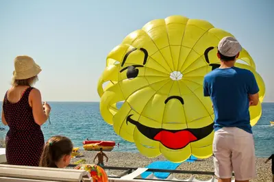 a group of people standing on a beach with a large kite at MY CASA - 46 GIOFFREDO - Central 1 bedroom in Nice