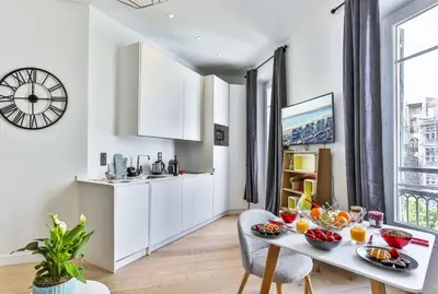 a kitchen with white cabinets and a table with food on it at MY CASA - 46 GIOFFREDO - Central 1 bedroom in Nice