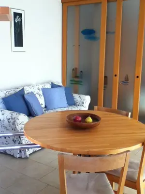 a wooden table with a bowl of fruit on top at The Dina Palace. in Villefranche-sur-Mer