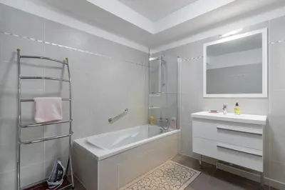 a white bathroom with a tub and a sink at Residence Blue Harmony in Nice