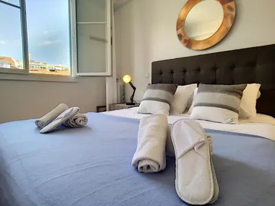 a bedroom with a bed with towels and a mirror at Nestor&Jeeves - FIORA PARADISE TERRACE - Central - Very close sea in Nice