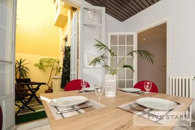 a dining room with a wooden table and red chairs at Suite Gioia five stars holiday house in Nice