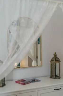 a mirror on top of a dresser in a room at 