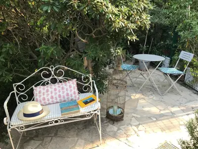 a white bench with a hat and books on it at 