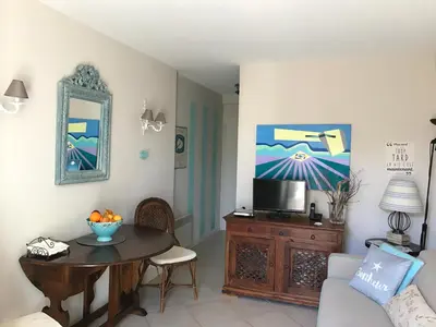 a living room with a table and a tv at 