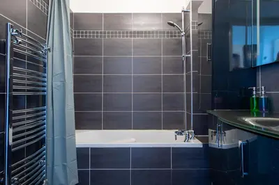 a bathroom with a bath tub and a sink at SEA FRONT SUITE - Panoramic View with Terrace - 85 m in Nice