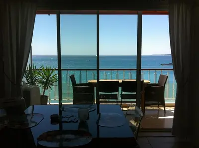 a room with a table and a view of the ocean at Cros De Cagnes in Cagnes-sur-Mer