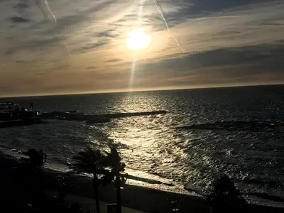 a sunset over the ocean with the sun in the sky at Cros De Cagnes in Cagnes-sur-Mer