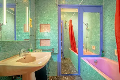 a bathroom with a sink and a pink tub at Big apart 140m2 5min walk to beach sea &Promenade 3 double rooms,big living room 42m2, 3 showers,9 beds, free parking in Nice