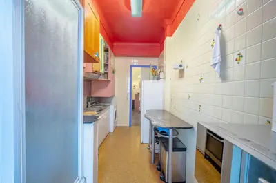 a kitchen with white counters and a refrigerator at Big apart 140m2 5min walk to beach sea &Promenade 3 double rooms,big living room 42m2, 3 showers,9 beds, free parking in Nice