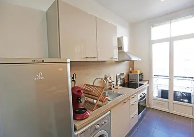 a kitchen with a stainless steel refrigerator and a sink at Splendid apart in the heart of Nice in Nice