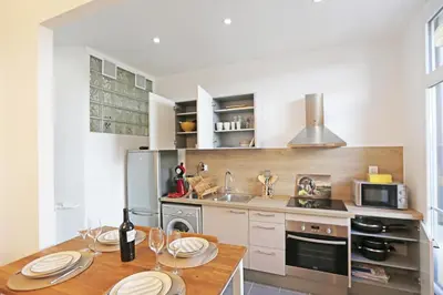 a kitchen with a table with plates on it at Splendid apart in the heart of Nice in Nice