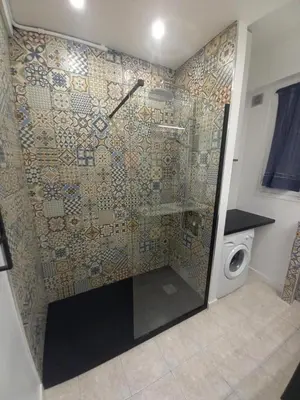 a shower in a bathroom with a washing machine at Le Catinat in Nice