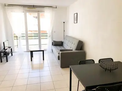 a living room with a couch and a table at Arson Riquier Port in Nice