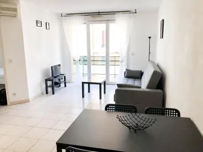 a living room with a couch and a table at Arson Riquier Port in Nice