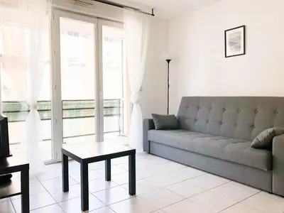 a living room with a couch and a table at Arson Riquier Port in Nice