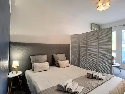 a bedroom with a large bed with towels on it at Nestor&Jeeves - NEVADA SUITE - Central - Close sea in Nice