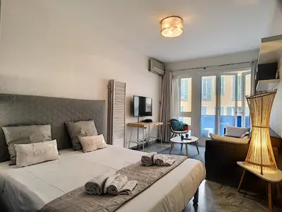 a bedroom with a large bed with towels on it at Nestor&Jeeves - NEVADA SUITE - Central - Close sea in Nice