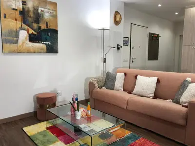 a living room with a couch and a glass table at Rigoletto Massena in Nice