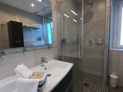 a bathroom with a sink and a shower at Coccinelle in Nice