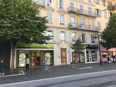a group of shops in front of a building at Coccinelle in Nice