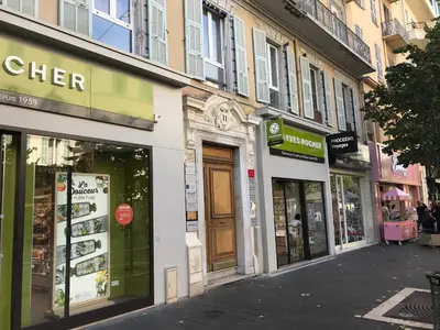 a group of shops on a city street at Coccinelle in Nice