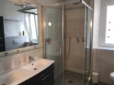 a bathroom with a sink and a glass shower at Coccinelle in Nice