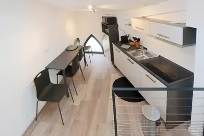 a kitchen with a counter and a table and chairs at Patio Wilson in Nice