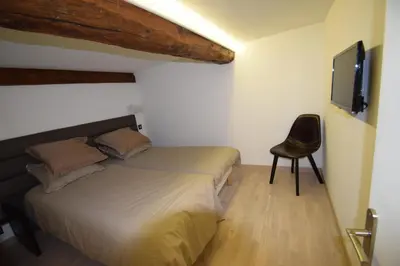 a bedroom with a bed and a chair and a television at Perla Duplex - No Better Location In Nice in Nice