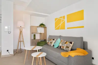a living room with a gray couch and two tables at Suite Relax Five Stars Holiday House in Nice
