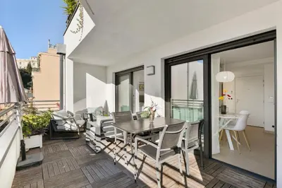 a dining room with a table and chairs on a balcony at Suite Relax Five Stars Holiday House in Nice