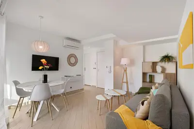 a living room with a couch and a dining room at Suite Relax Five Stars Holiday House in Nice