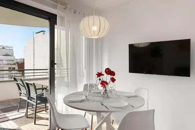 a white dining room with a table and chairs at Suite Relax Five Stars Holiday House in Nice