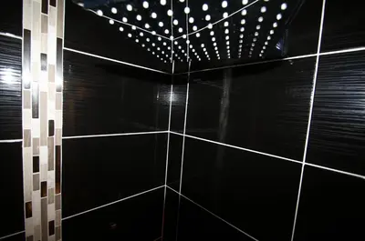a black tiled wall with white polka dots at WAVEBNB All Confort, central, parking in Nice