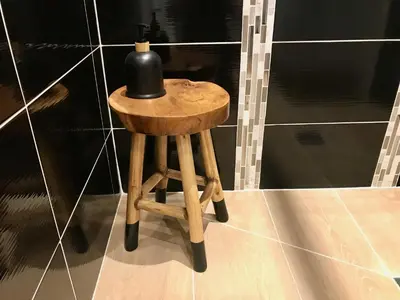 a small wooden stool with a black bottle on it at WAVEBNB All Confort, central, parking in Nice