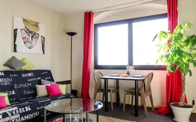 a living room with a couch and a table at Cosy - Negresco - AC - 5 min walk to Beach in Nice