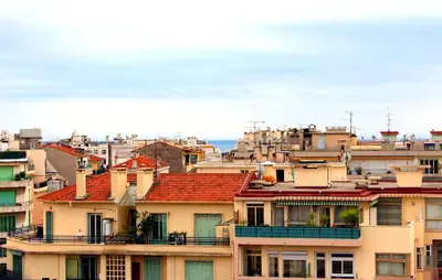a group of buildings with red roofs at Cosy - Negresco - AC - 5 min walk to Beach in Nice