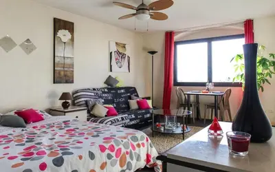 a bedroom with a bed and a living room at Cosy - Negresco - AC - 5 min walk to Beach in Nice