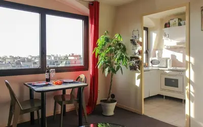 a dining room with a table and a window at Cosy - Negresco - AC - 5 min walk to Beach in Nice