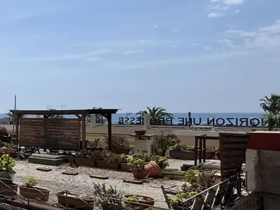 a patio with potted plants on the beach at ApartHotel Riviera Nice Côte d'Azur - Old Town - Studio AC - Sea View - 50m Promenade des Anglais- LA MAISON LINDA in Nice