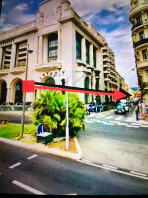 a sign on a street in front of a building at Amour-35 in Nice