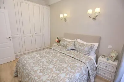 a bedroom with a bed and a night stand and lights at Le Charme-35 in Nice